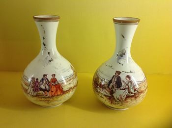 A pair of Wedgwood creamware vases, painted by Emile Lessore