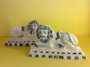 A very unusual pair of porcelainous models of lions 