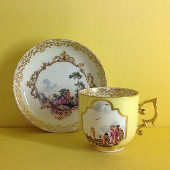 A Meissen yellow ground coffee cup and a saucer 