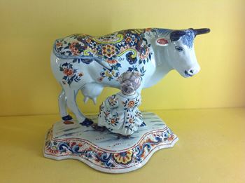A Dutch Delft cow and milkmaid group 