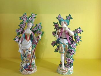 A pair of Chelsea figures of a woodcutter and companion