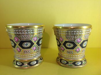 A pair of unusual Coalport jardinieres and stands