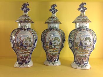 A garniture of Dutch Delft vases and covers 