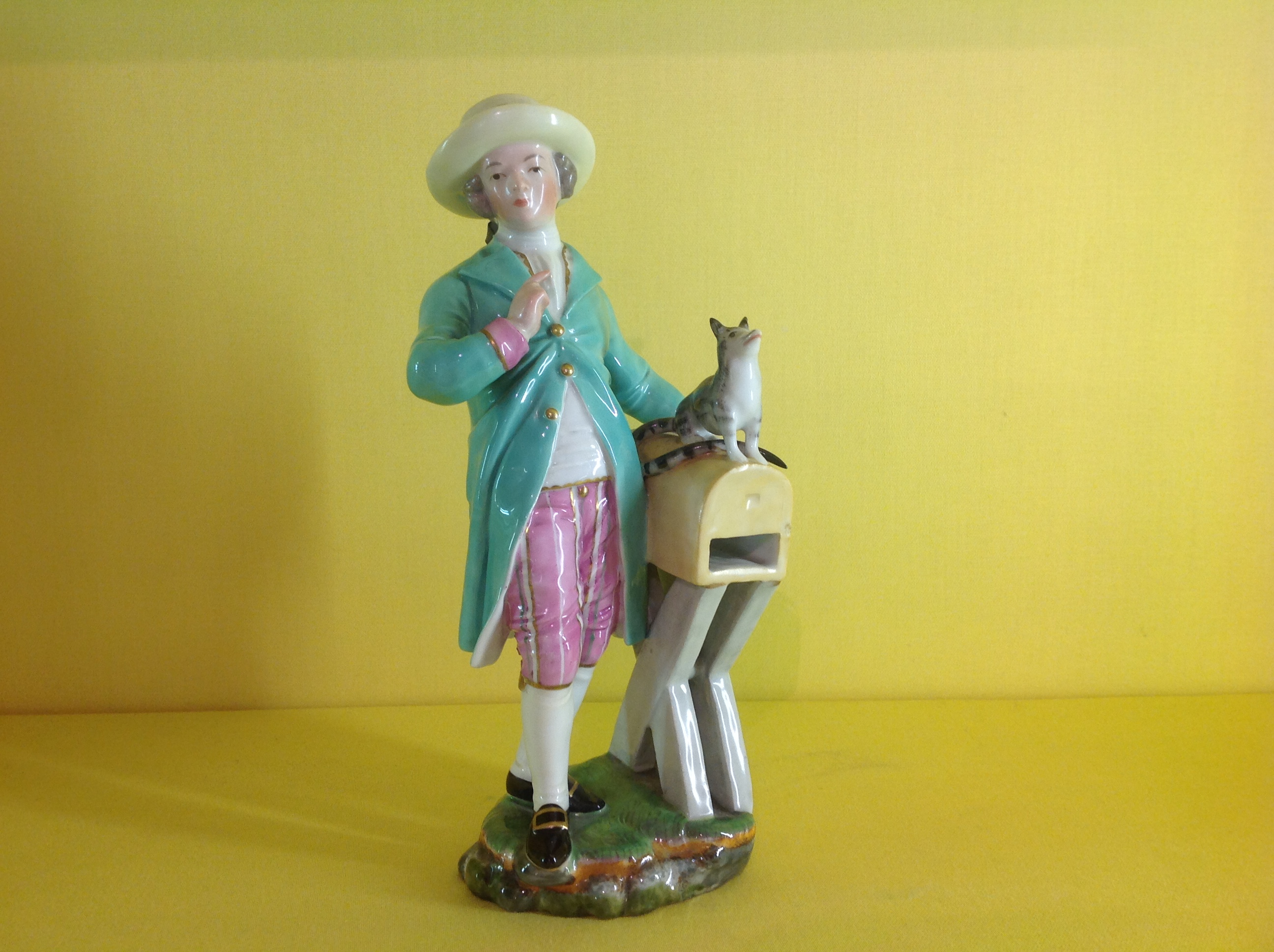 A Hochst figure of a young man with a cat