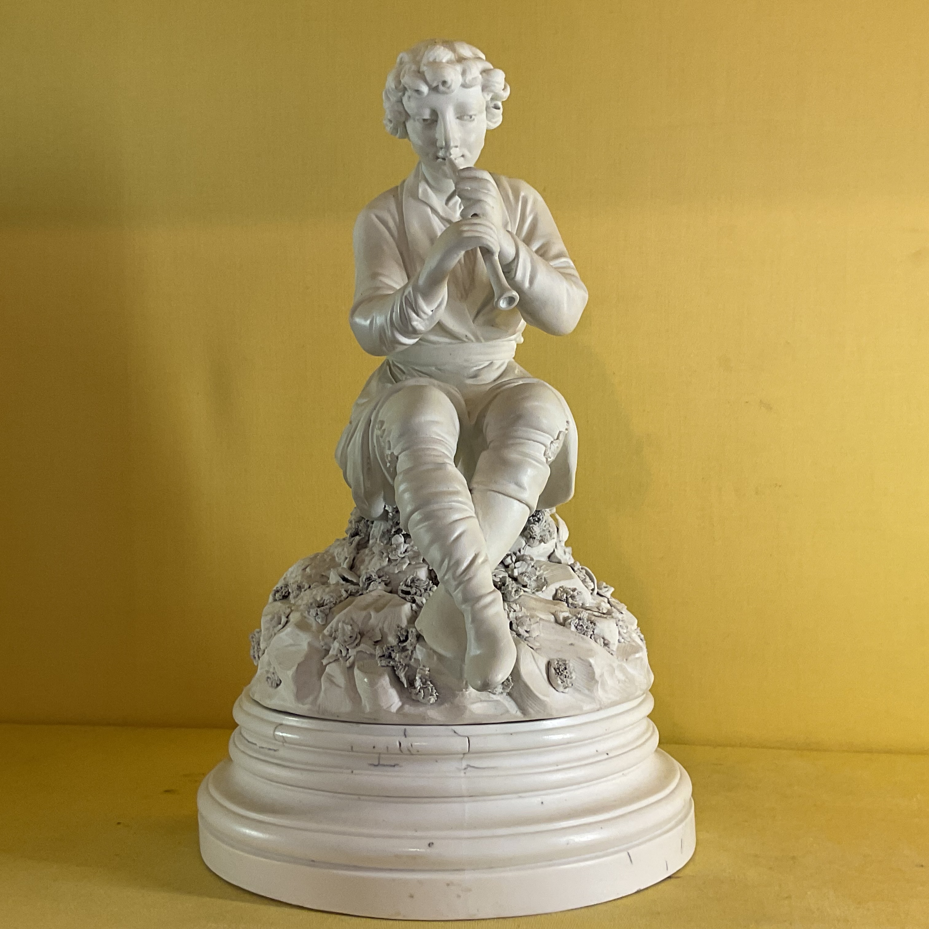 A rare Derby biscuit porcelain figure of a young man 