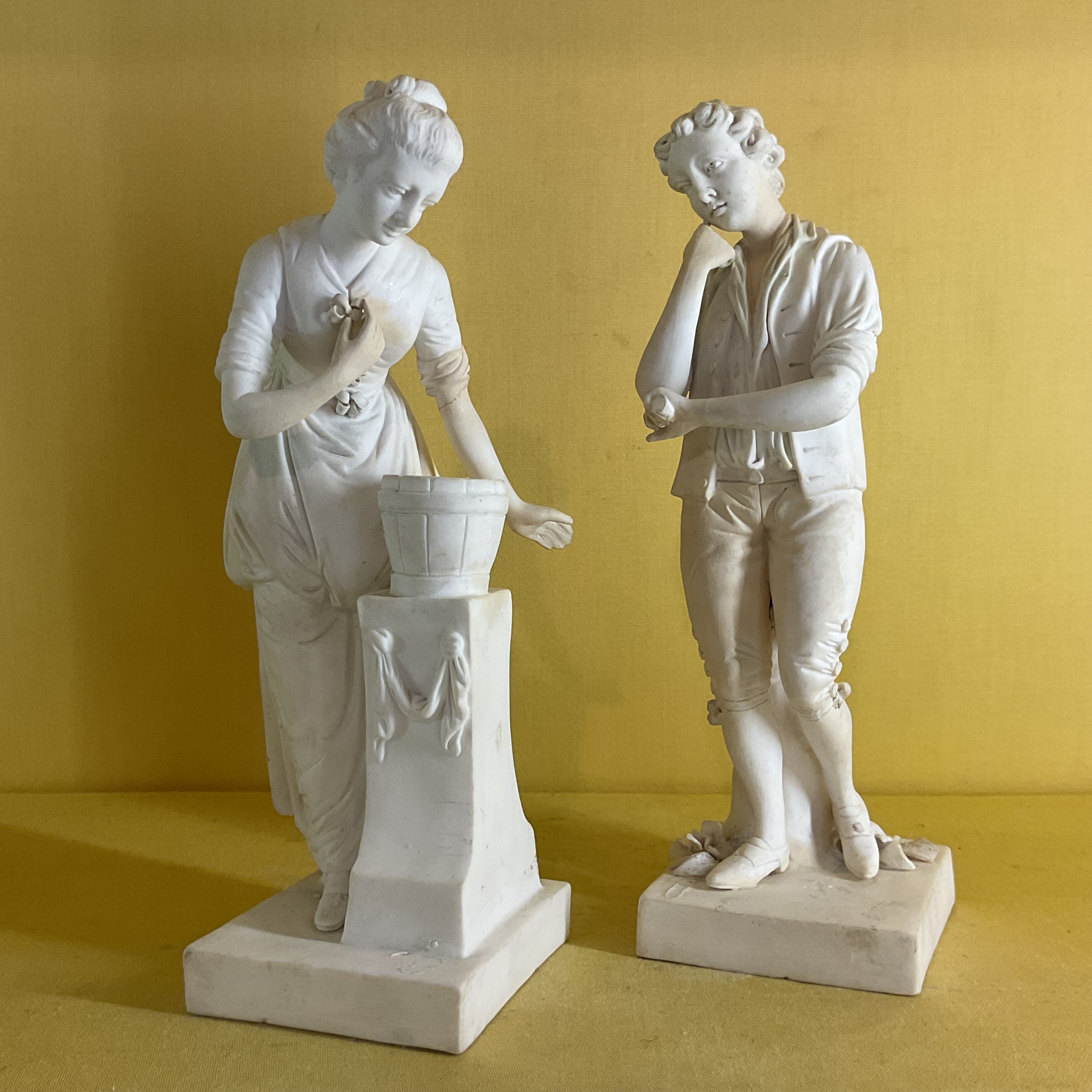 A pair of Derby biscuit porcelain figures of a Gardener and Companion 