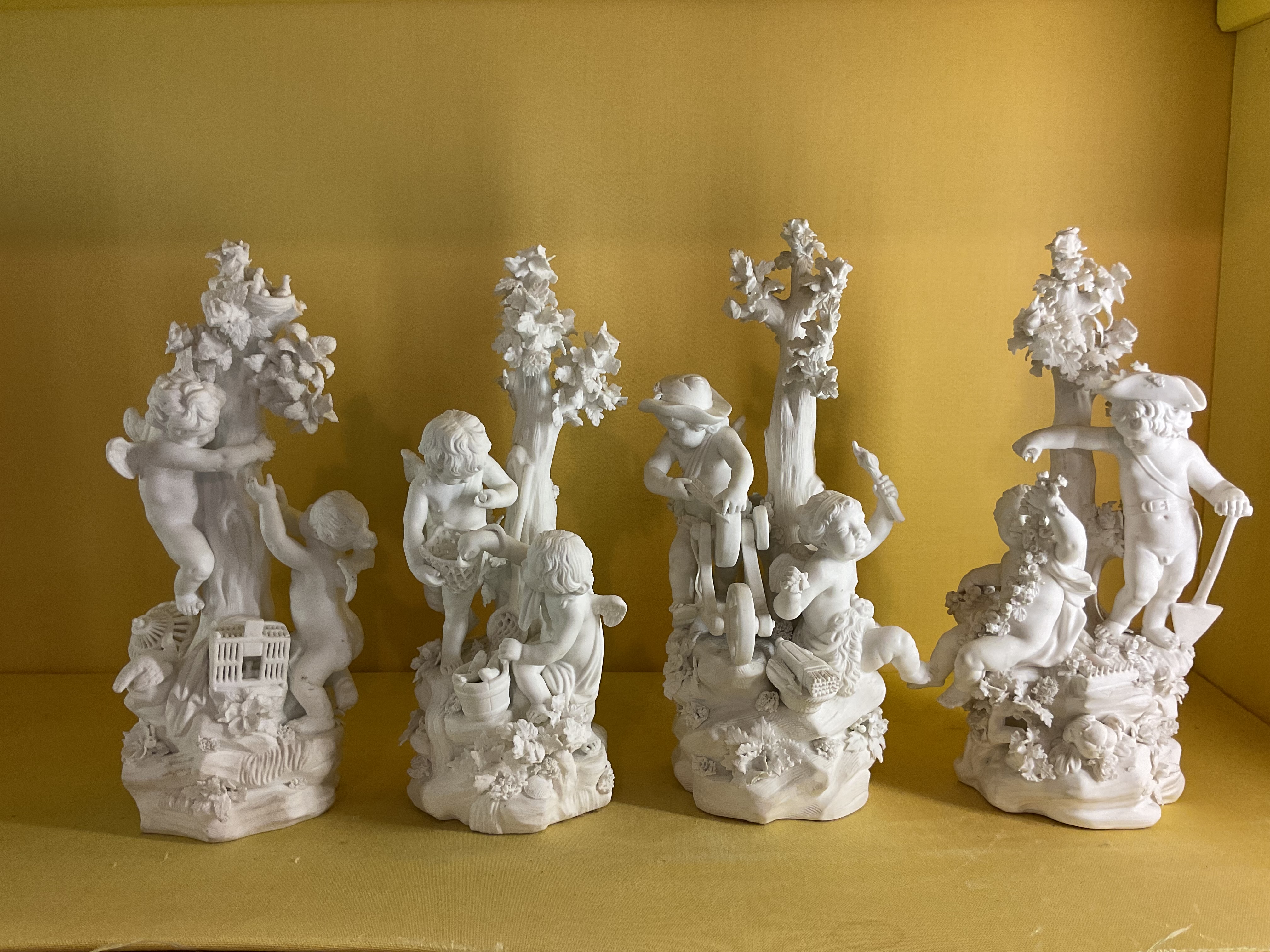 A set of four Derby biscuit porcelain groups 