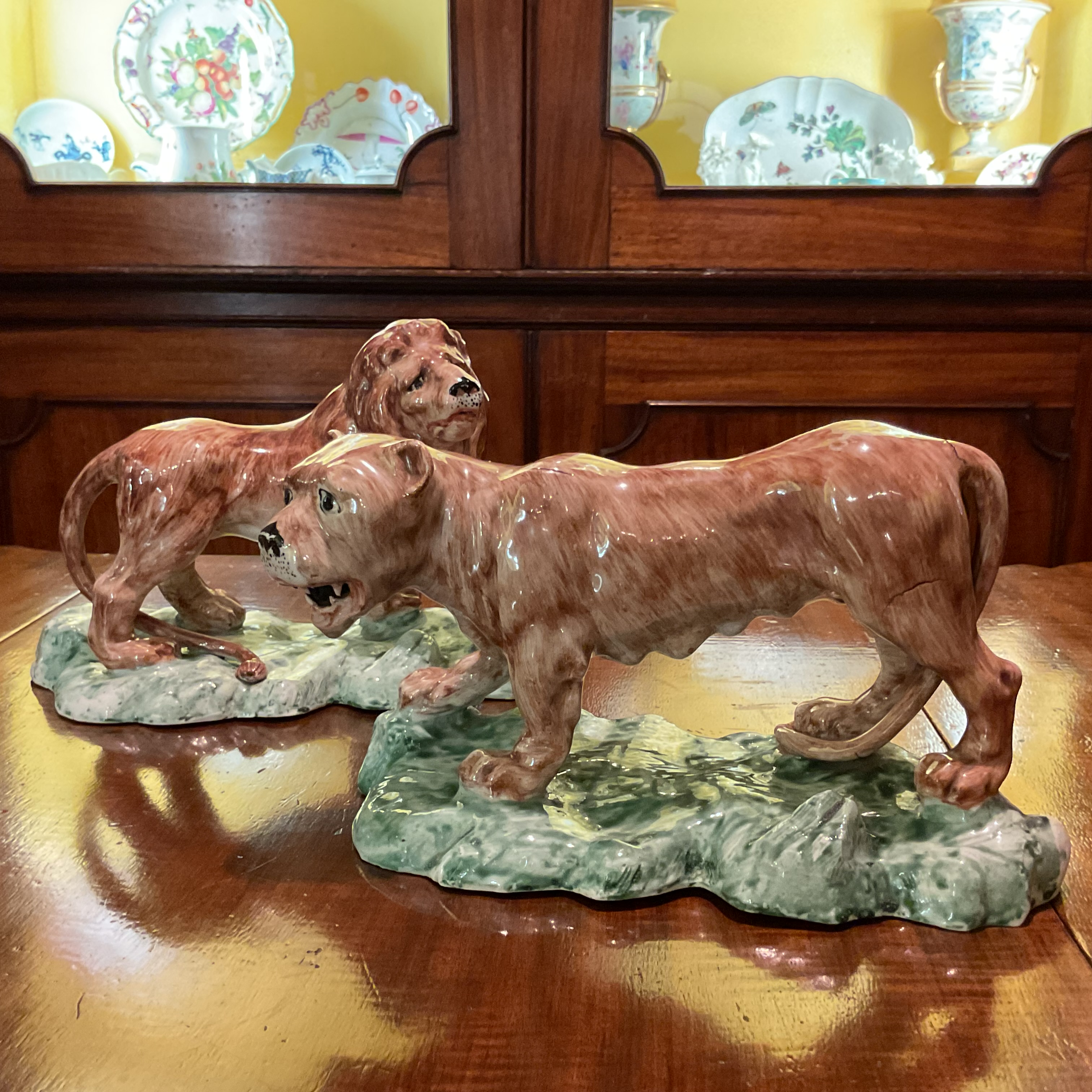 An unusual pair of 19th century Continental porcelain large models of a lion and lioness 
