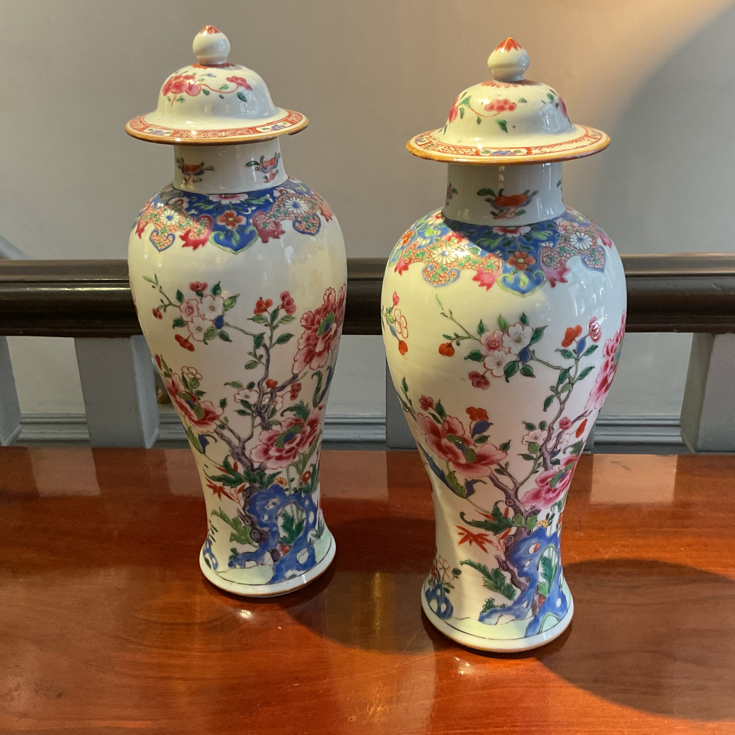 A pair of Chinese Export famille rose vases and covers 