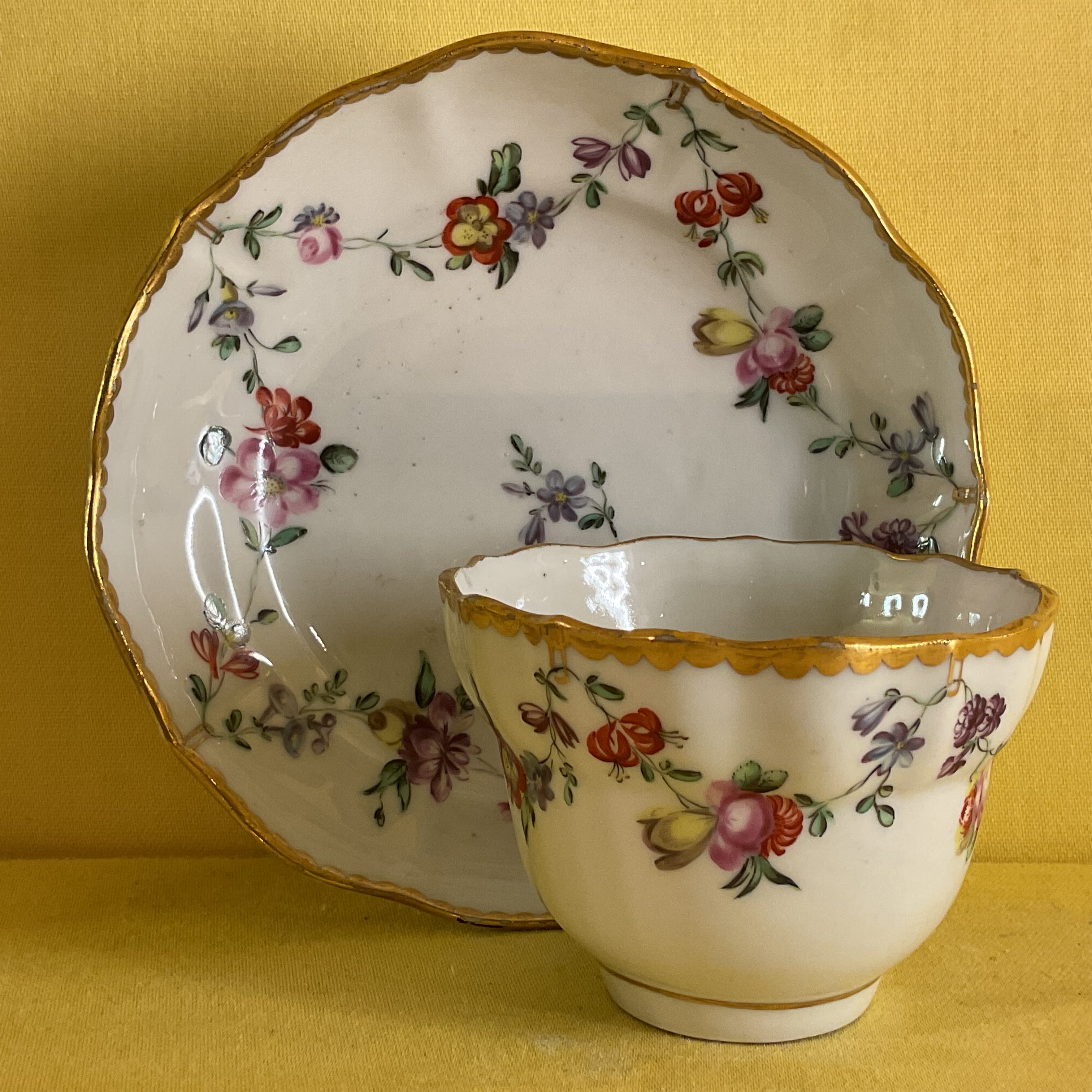 A Bristol small ogee shaped tea bowl and saucer 