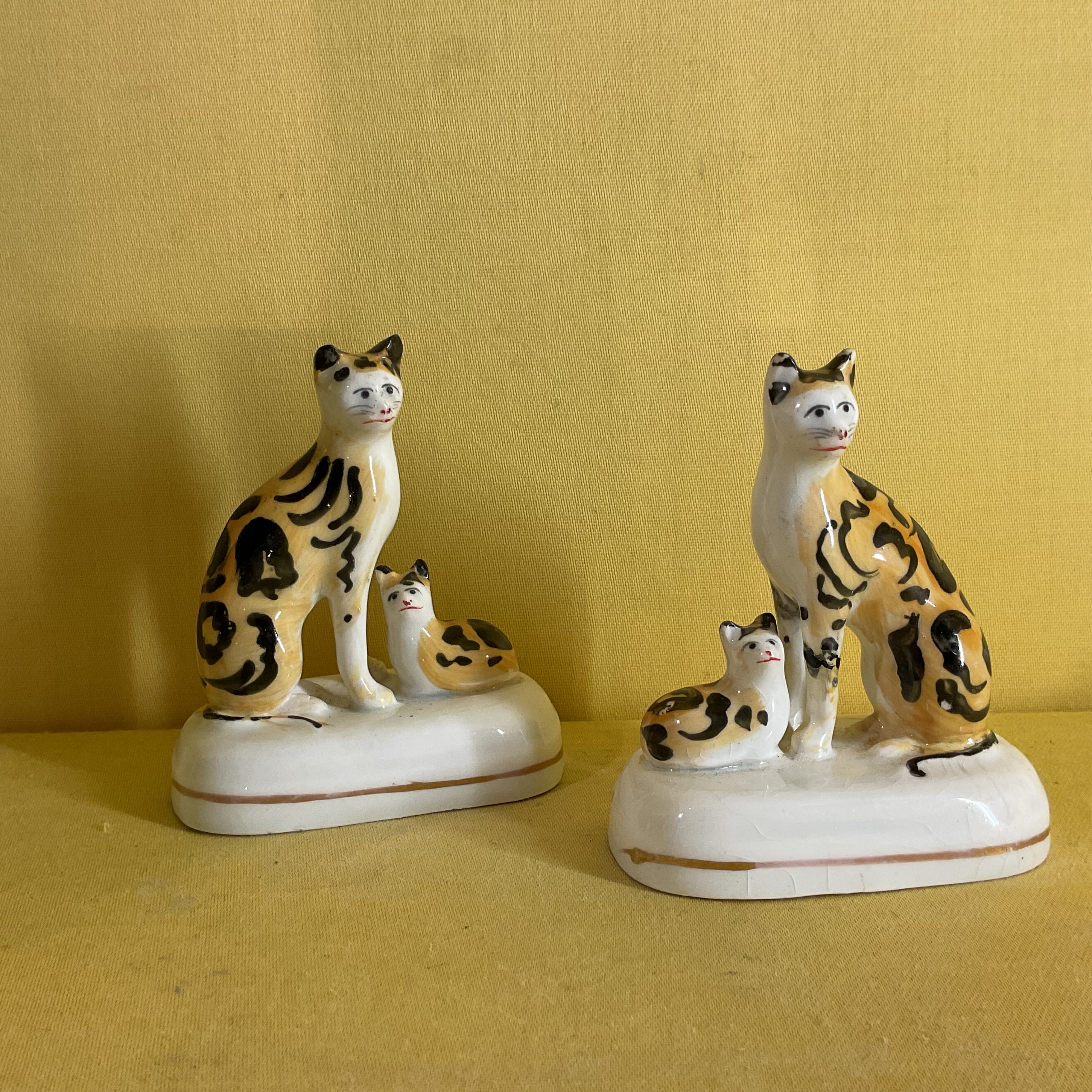 A good pair of Staffordshire porcelain models of a cat and kitten 