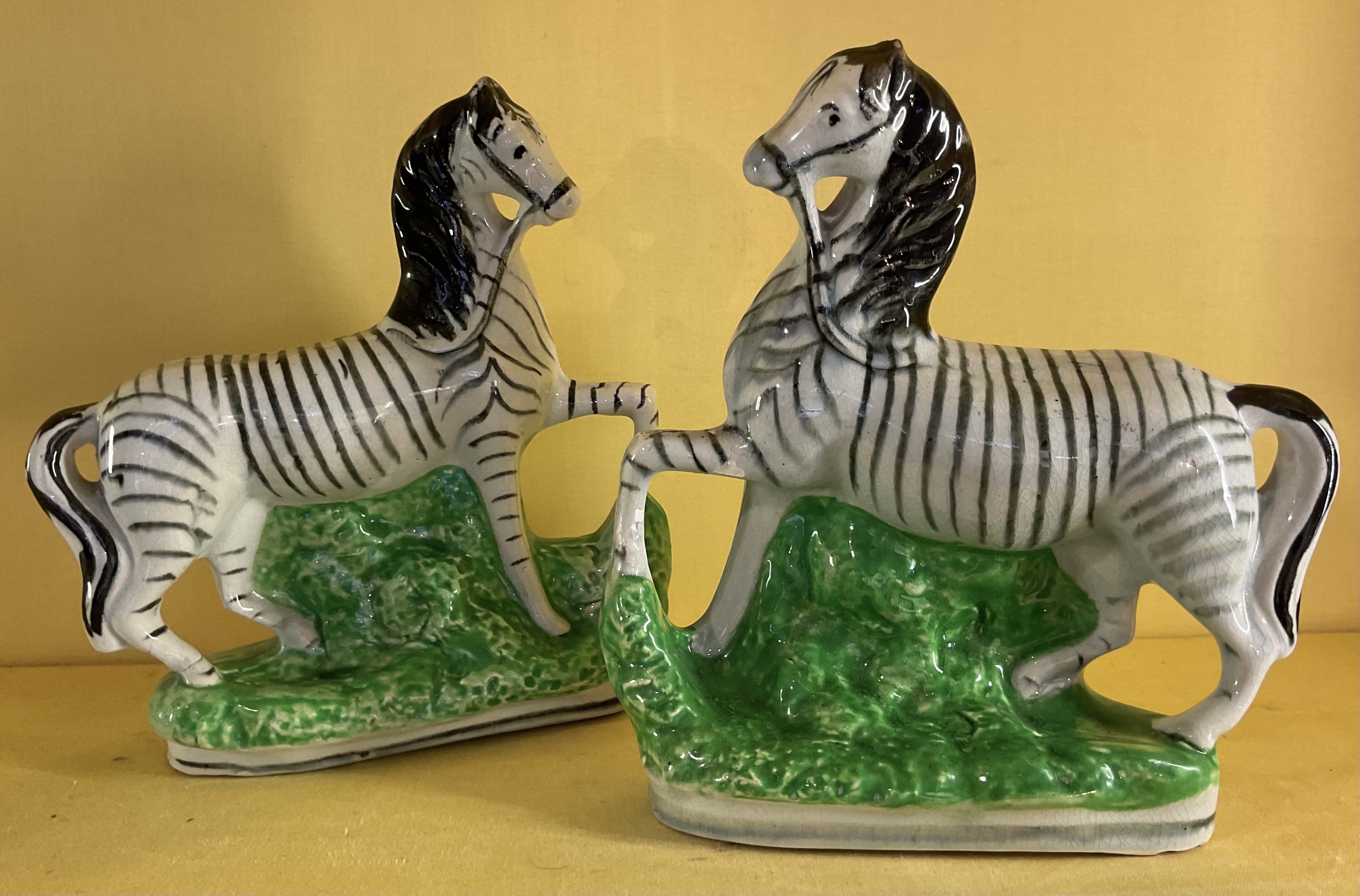 A pair of pottery models of Zebra