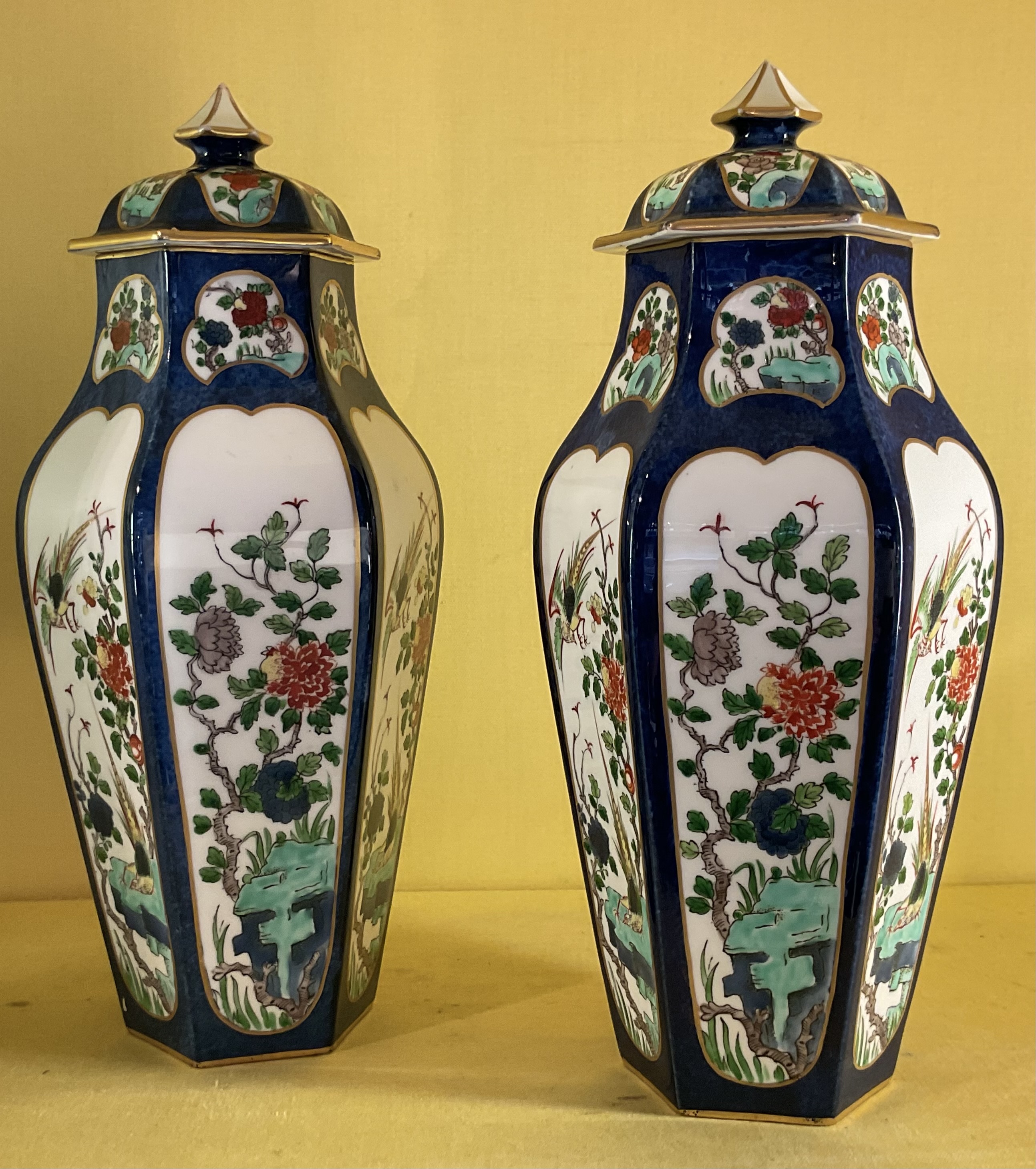 A pair of Crown Staffordshire hexagonal vases and covers 
