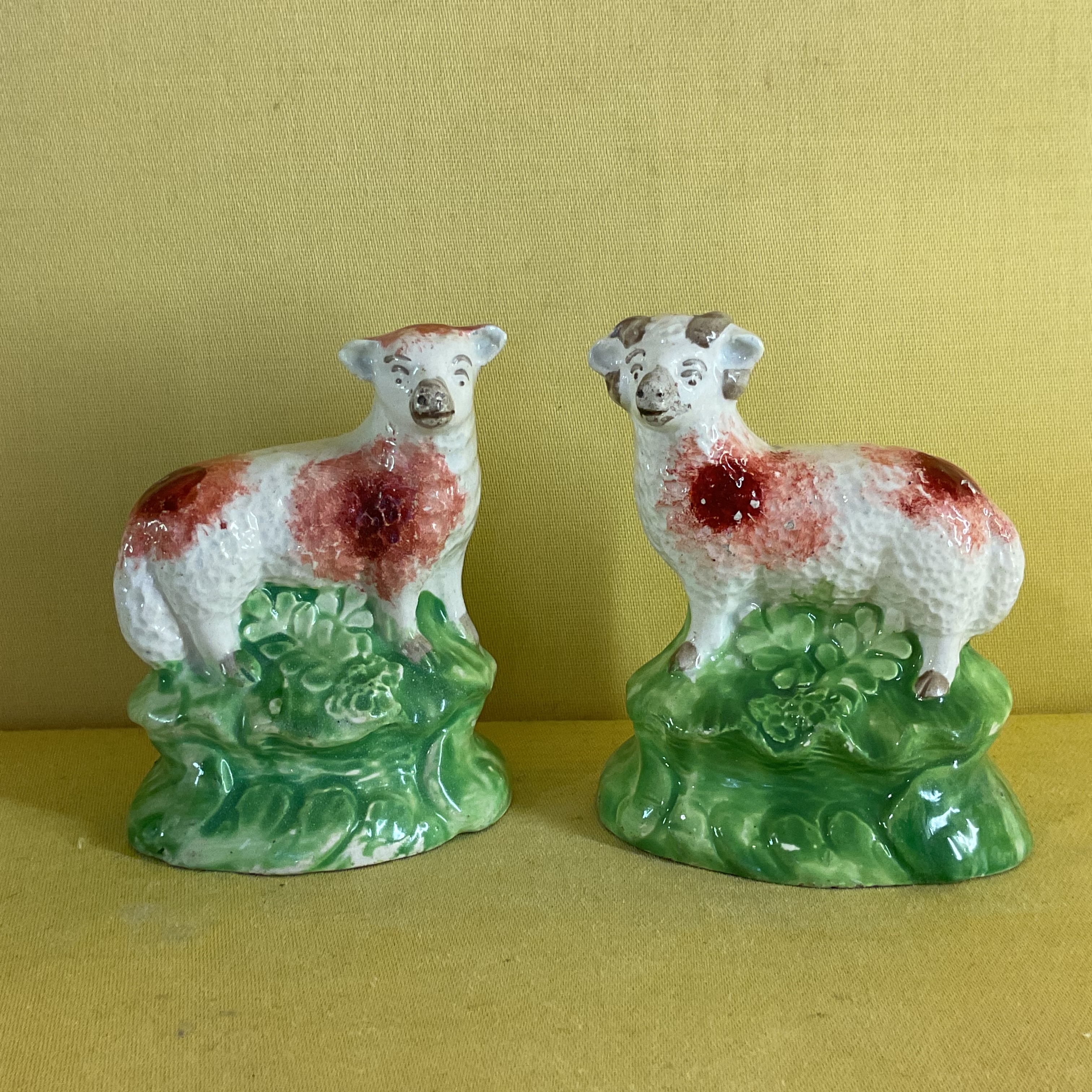 A pair of pearlware small models of a ewe and a ram 