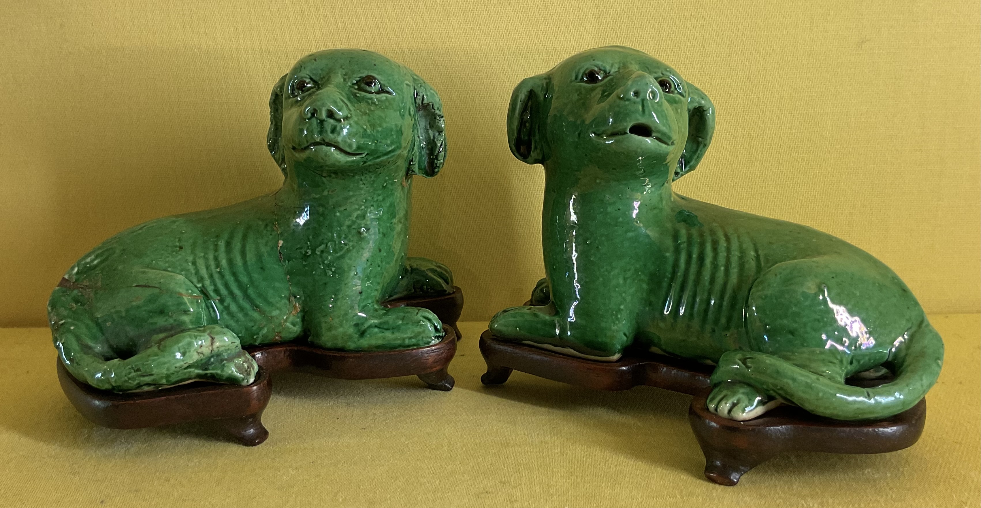 A pair of Chinese green glazed small models of dogs 