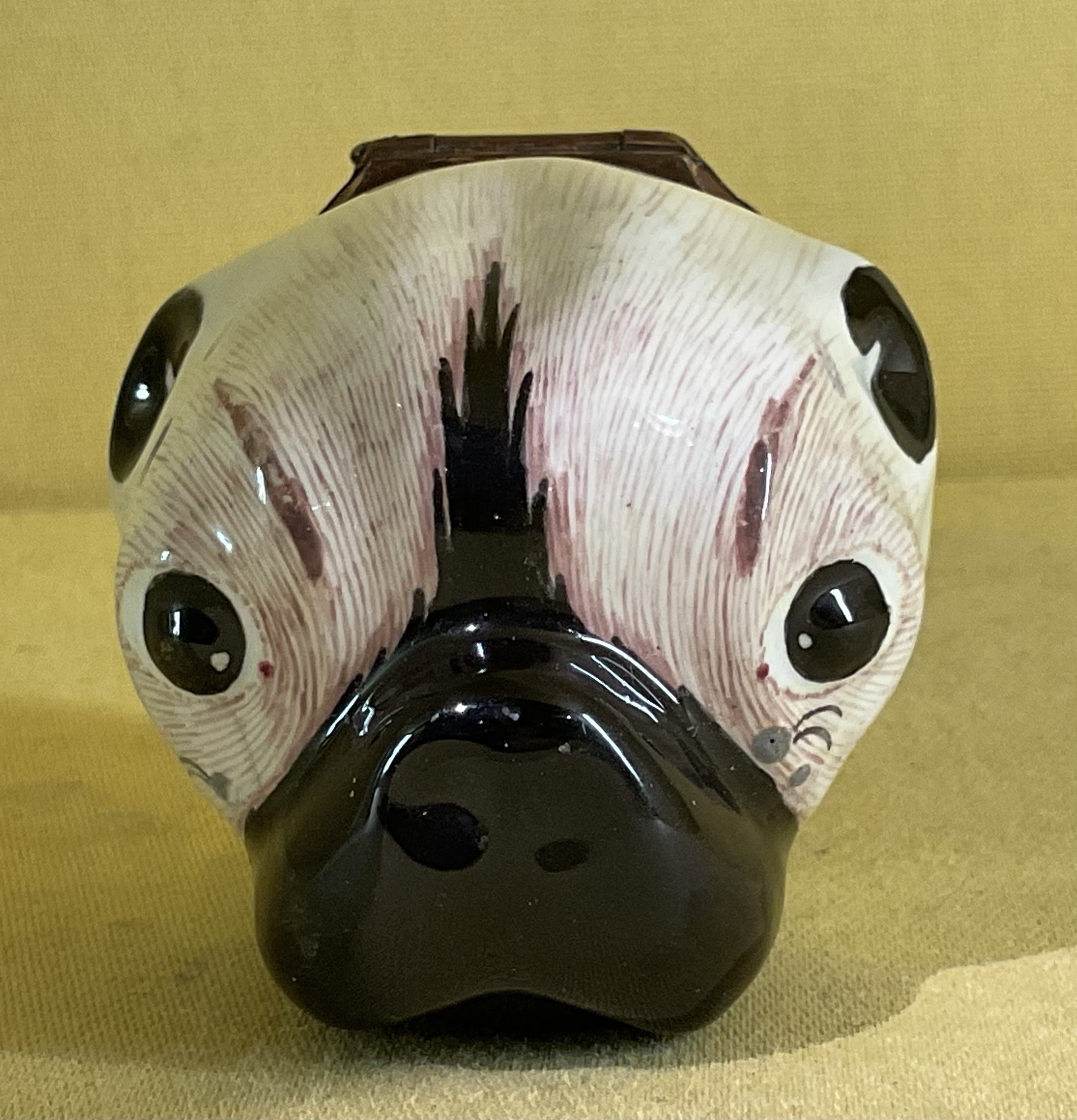 A Staffordshire enamel pug head bonbonniere 