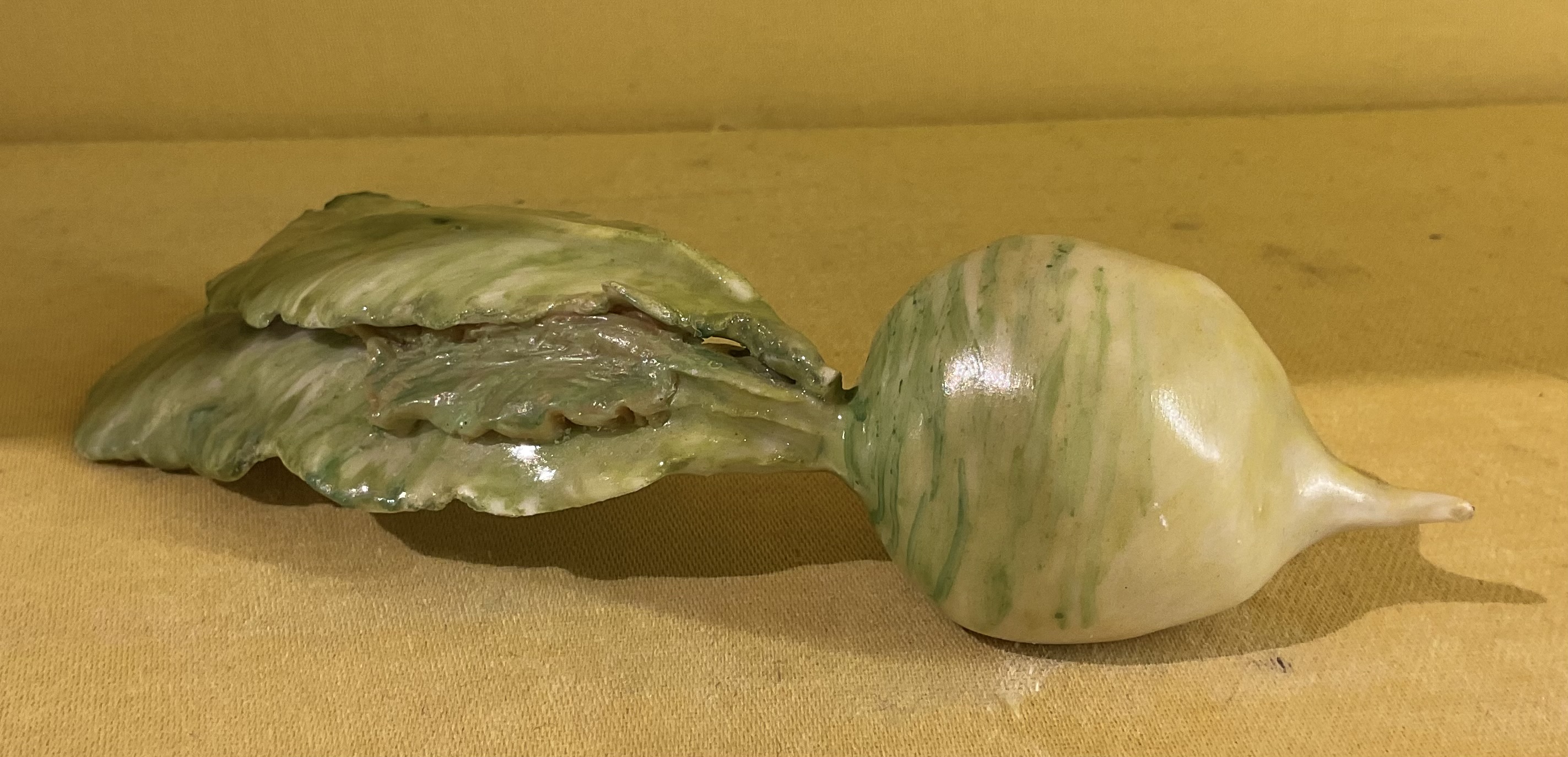 An unusual Anne Gordon (Marchioness of Aberdeen) model of a green radish 