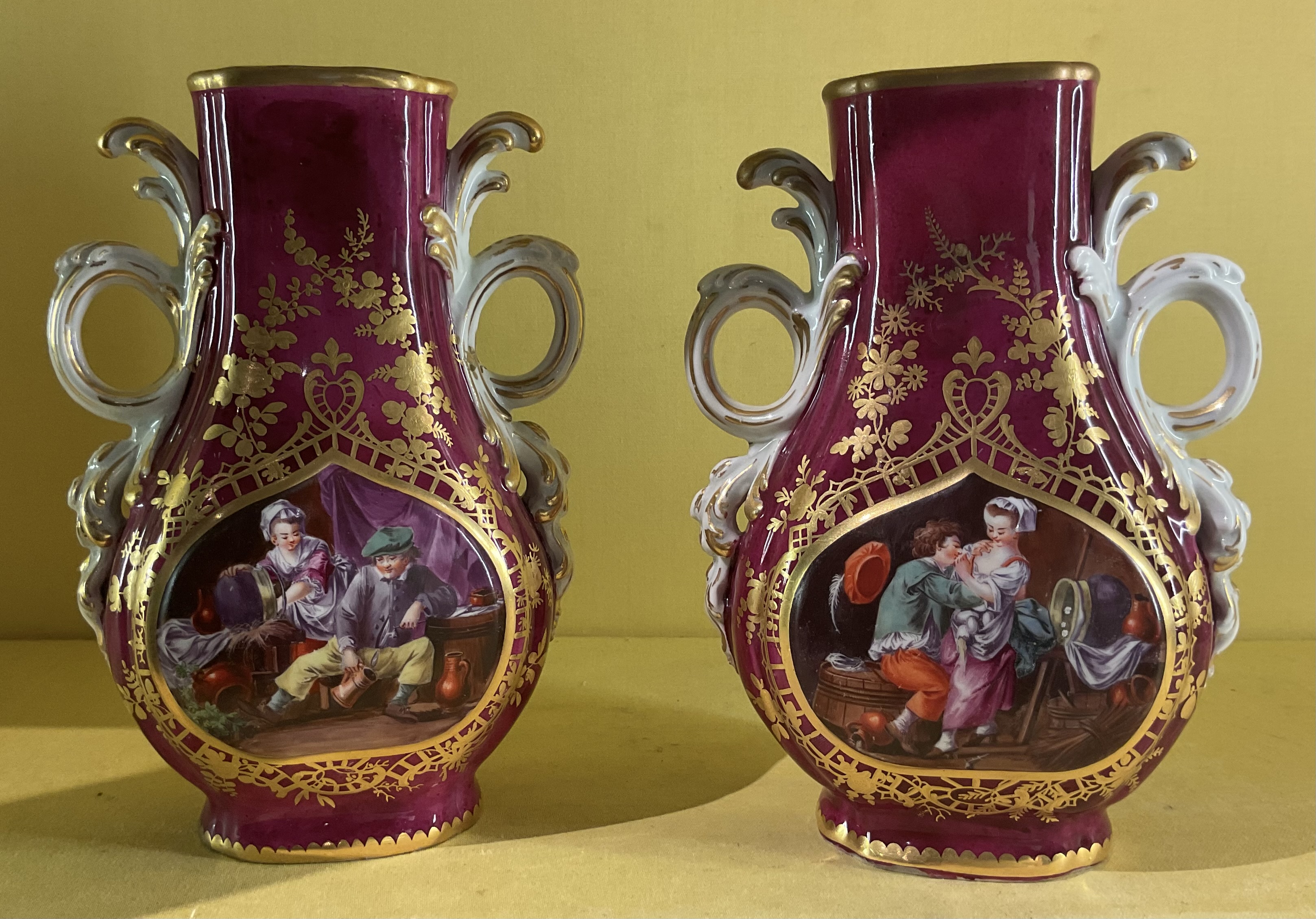 A pair of Chelsea claret ground vases 