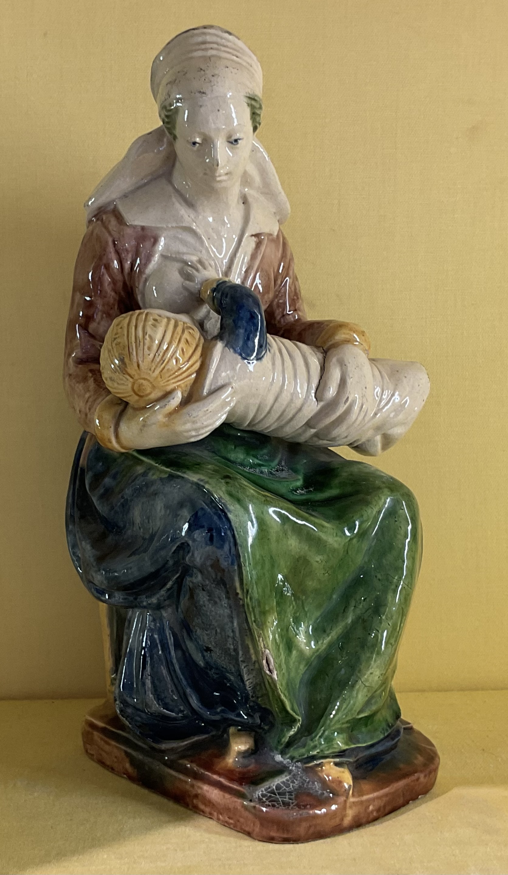 A rare French earthenware figure of La Nourrice 