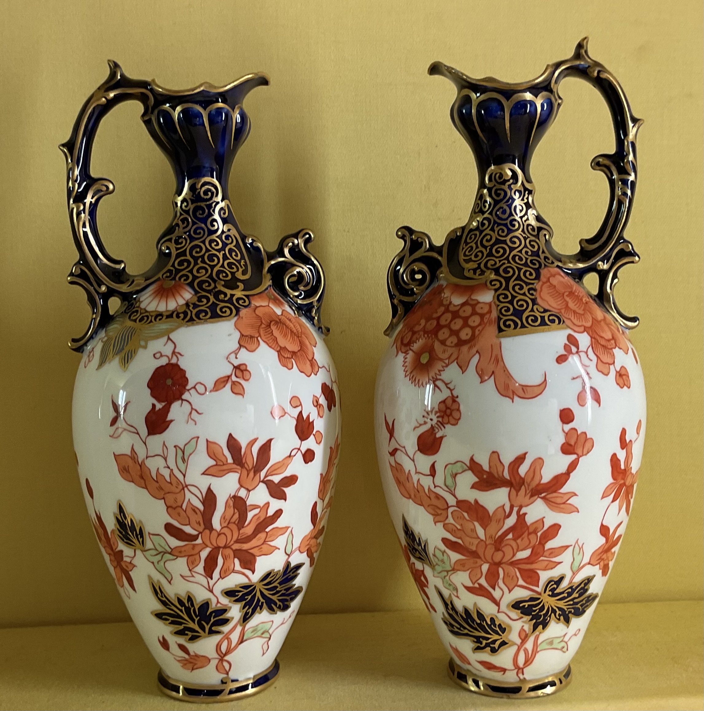 A pair of Royal Crown Derby ewers 